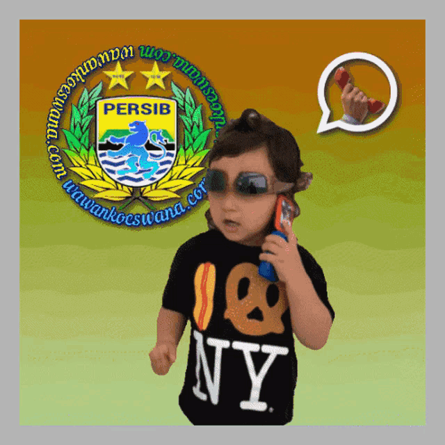 a child wearing a ny shirt talking on a cell phone