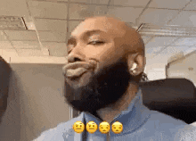 a man with a beard is making a funny face with his tongue out .