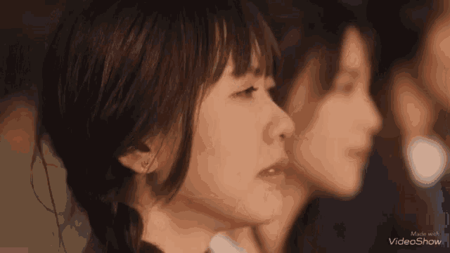 a group of young women are standing next to each other and one of the girls is crying .