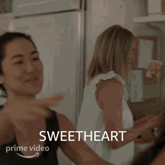 a woman hugging another woman with the word sweetheart on the bottom right
