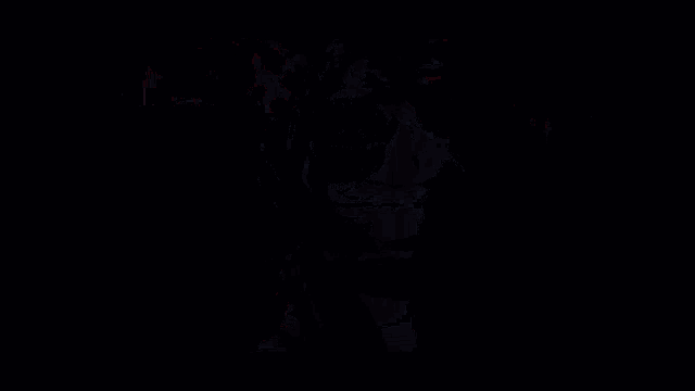 a black and white gradient background with a few spots of red .