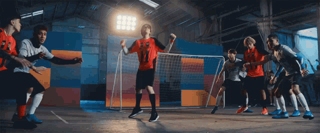 a group of soccer players are playing a game and one of them has the number 11 on his jersey