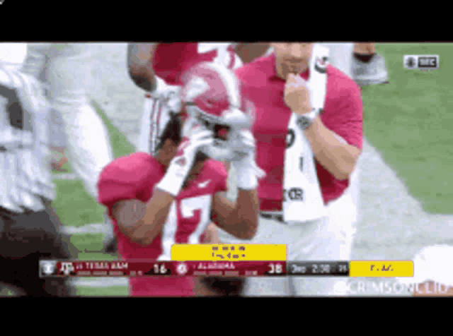 a football player wearing a number 7 jersey holds his helmet