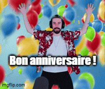 a man wearing headphones and a shirt that says bon anniversaire is surrounded by balloons