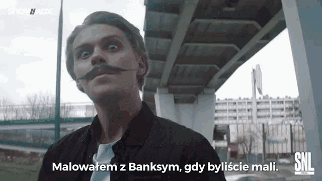 a man with a mustache and a snl logo