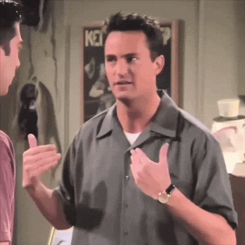 a man is giving a thumbs up while talking to another man