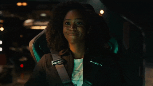 a woman is smiling while wearing a black jacket