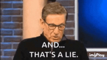 a man wearing glasses is sitting in front of a brick wall and says `` and ... that 's a lie . ''