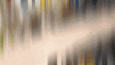 a blurred image of a waterfall with a few trees visible
