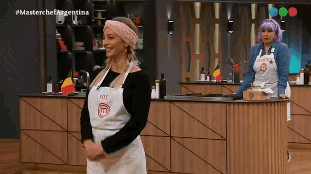a woman wearing an apron with sol on it