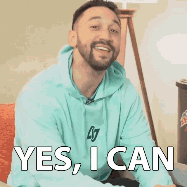 a man with a beard wearing a blue sweatshirt that says yes i can