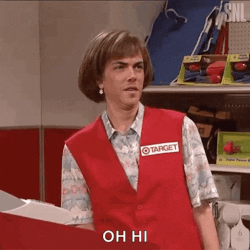 a man wearing a target vest is standing in front of a shelf .