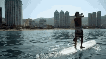 a man standing on a surfboard in the ocean