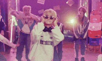 a group of young people are dancing in a room with signs that say keep out