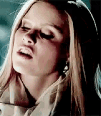 a close up of a woman 's face with her mouth open .