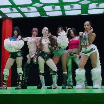 a group of women are posing for a picture and one of them is wearing a pink top