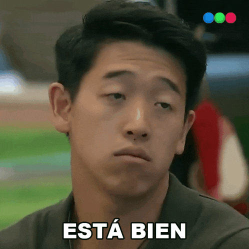 a man with a serious look on his face has the word bien written on his face
