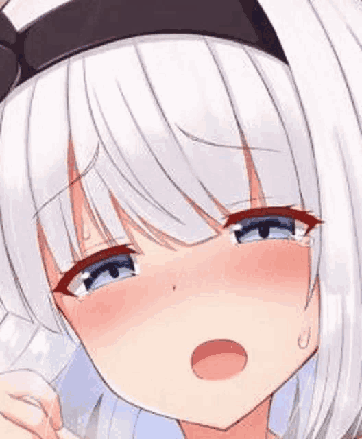 a girl with white hair and blue eyes is crying .