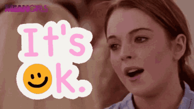 a woman says it 's ok with a smiley face in the background