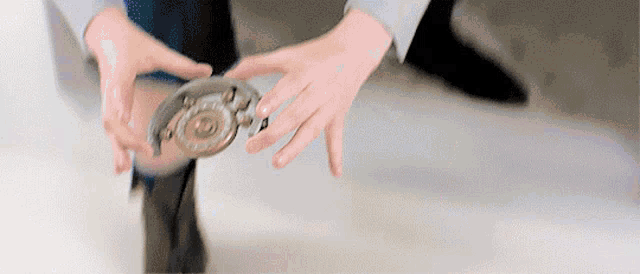 a person is holding a metal object in their hands