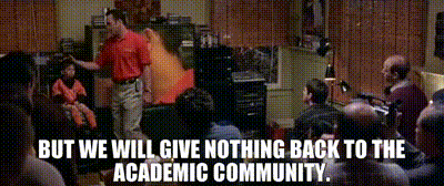 a man in a red shirt stands in front of a crowd with the words but we will give nothing back to the academic community