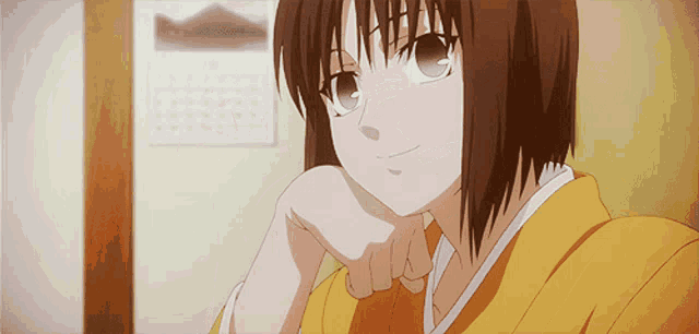a girl in a yellow kimono rests her head on her hand