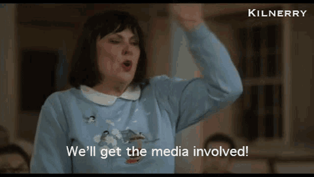 a woman in a blue sweater with penguins on it says we 'll get the media involved .