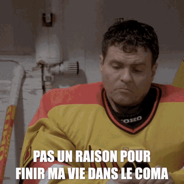 a man wearing a yellow and red jersey with the words pas un raison pour finir ma vie dans le coma below him