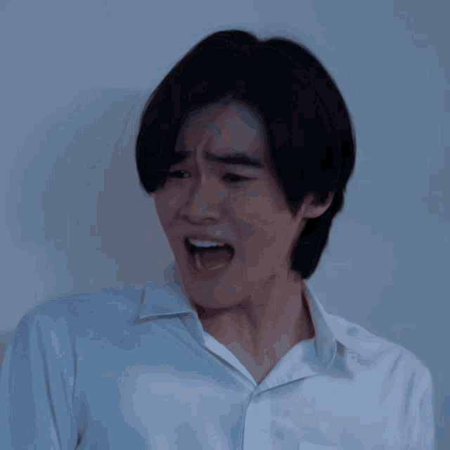 a man in a white shirt with his mouth open