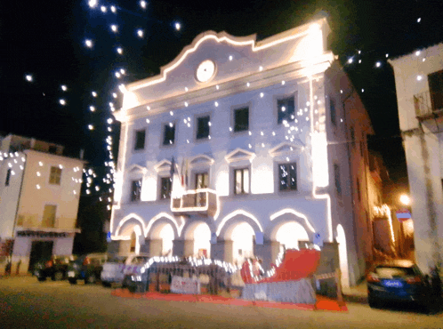 a white building with a clock on top of it