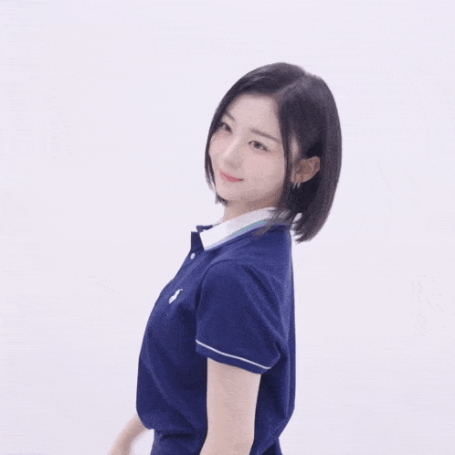 a woman wearing a blue polo shirt with a white collar