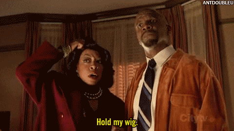 a man and a woman are standing next to each other and the man says hold my wig
