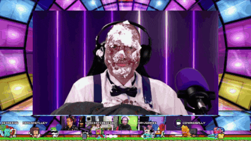 a man with whipped cream on his face is sitting in front of a microphone in a video game
