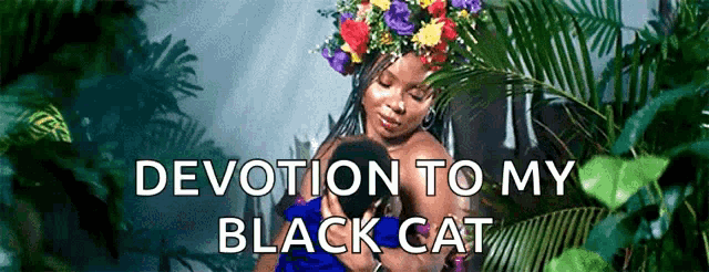 a woman with a flower crown on her head is holding a baby with the words devotion to my black cat written above her