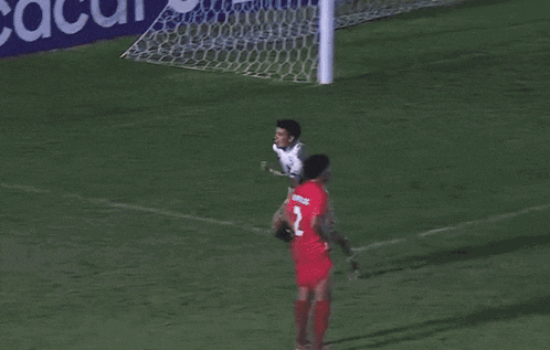 two soccer players are playing on a field and one of them is wearing a jersey that says ucla