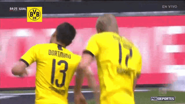 two soccer players wearing yellow jerseys with the number 13 on the back