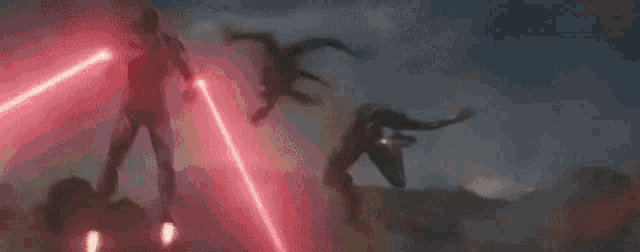 a man is flying through the air with a red laser beam .