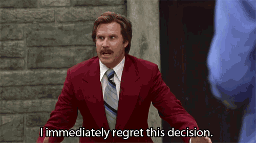 a man in a red suit and tie is saying " i immediately regret this decision "