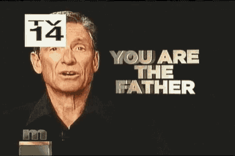 a man is speaking into a microphone with the words you are the father behind him