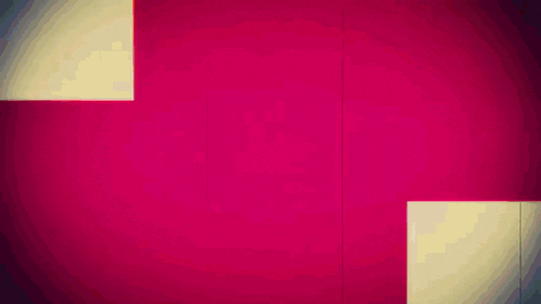 a pink and white cross is on a wall