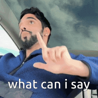 a man with a beard is giving a thumbs down sign and the words what can i say are visible behind him