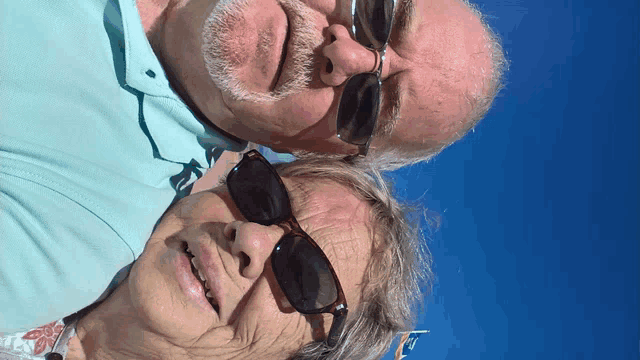 a man and a woman wearing sunglasses are looking up at the sky