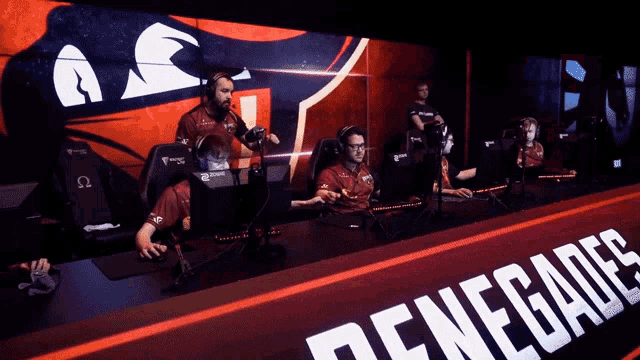 a group of renegades players sitting in front of a screen