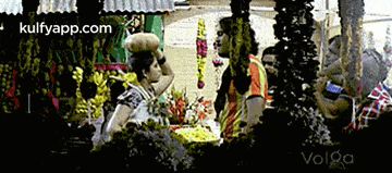 a group of people are gathered around a table with the website kulfyapp.com in the upper right corner