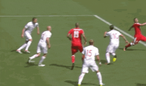 a soccer goalie is jumping to catch a ball in front of a banner that says ice box