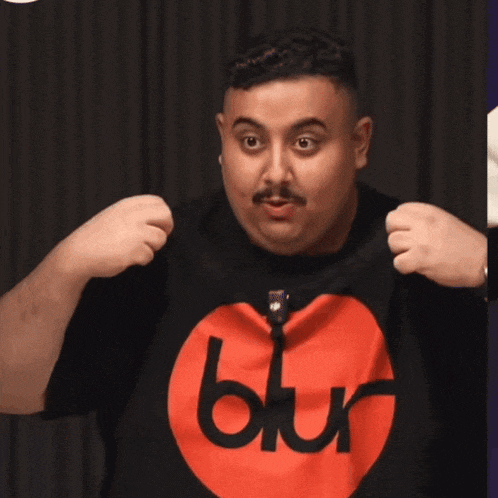 a man is wearing a black shirt with a red circle and the word blur on it