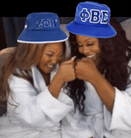 a woman wearing a blue hat with the letters obe on it