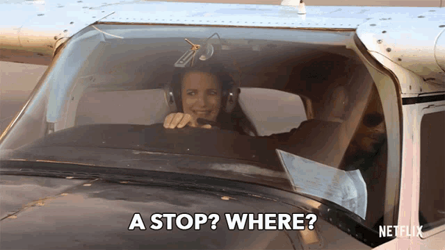a woman in a plane is asking where to stop