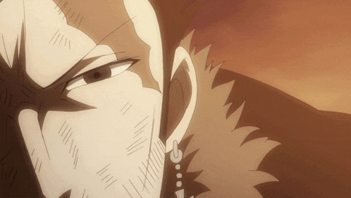 a close up of a person 's face with a beard and earrings