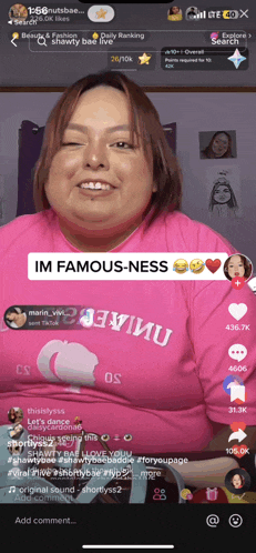 a woman in a pink shirt with the words im famous-ness